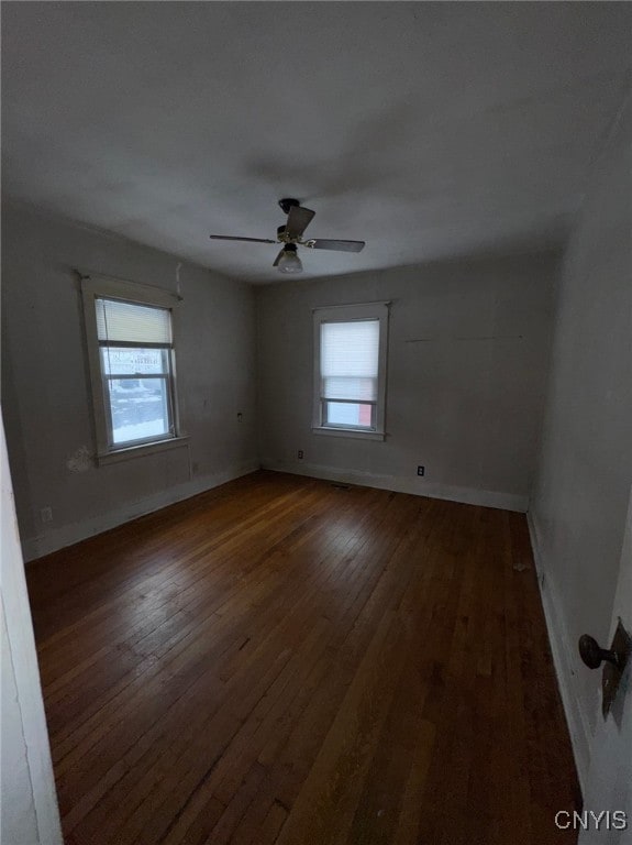 unfurnished room with ceiling fan and dark hardwood / wood-style floors