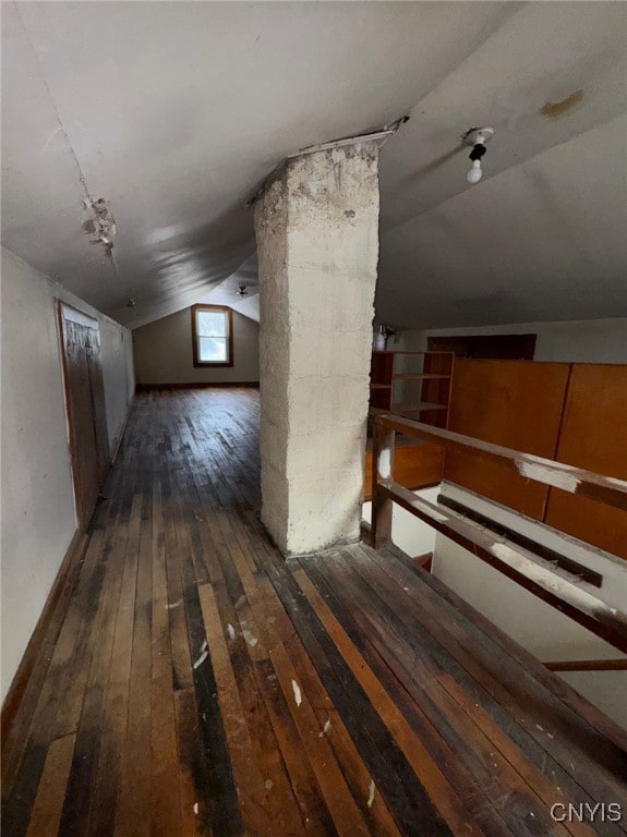 bonus room featuring lofted ceiling and dark wood-type flooring