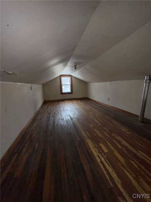 additional living space with dark hardwood / wood-style flooring and lofted ceiling