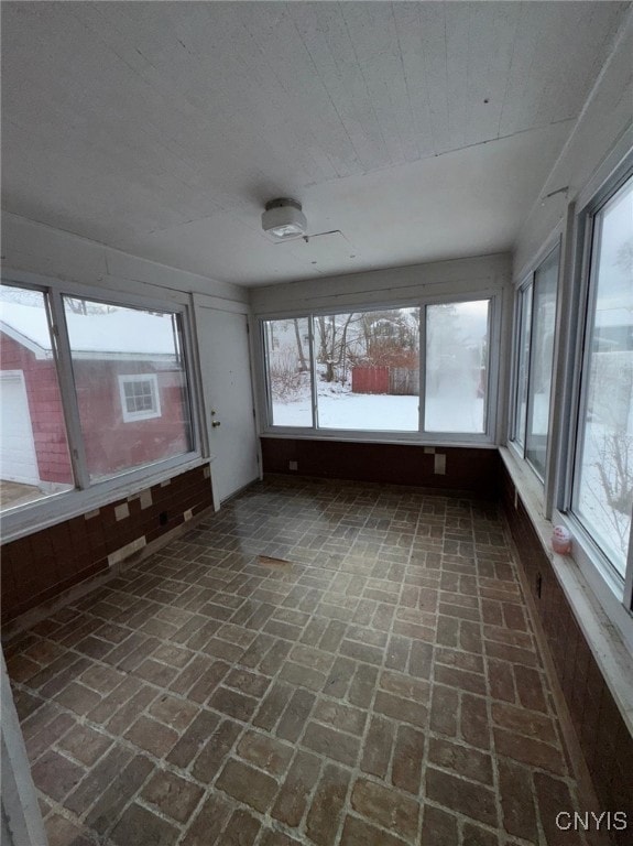 unfurnished sunroom with plenty of natural light