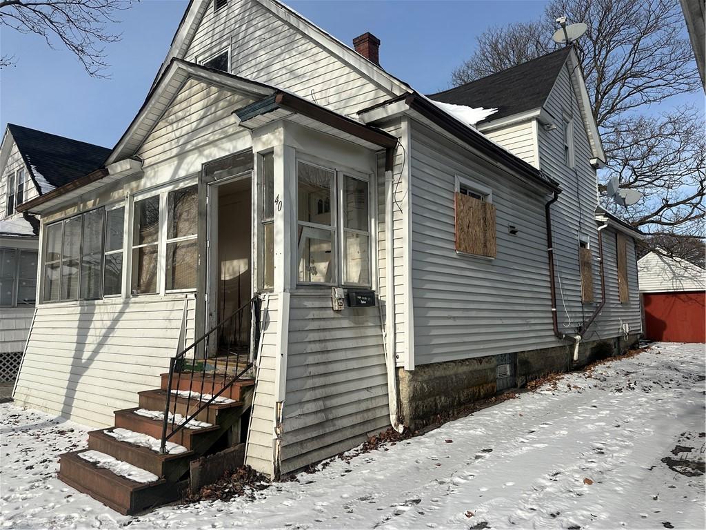 view of snowy exterior featuring a sunroom