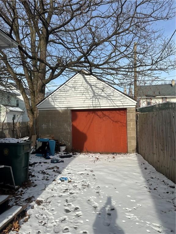 exterior space with a garage and an outbuilding