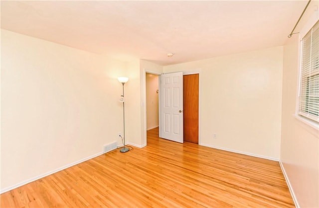 spare room with light hardwood / wood-style flooring