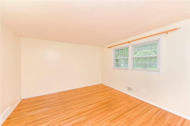 spare room with light hardwood / wood-style floors