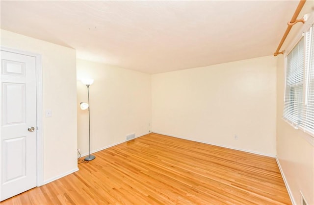 spare room with light hardwood / wood-style floors