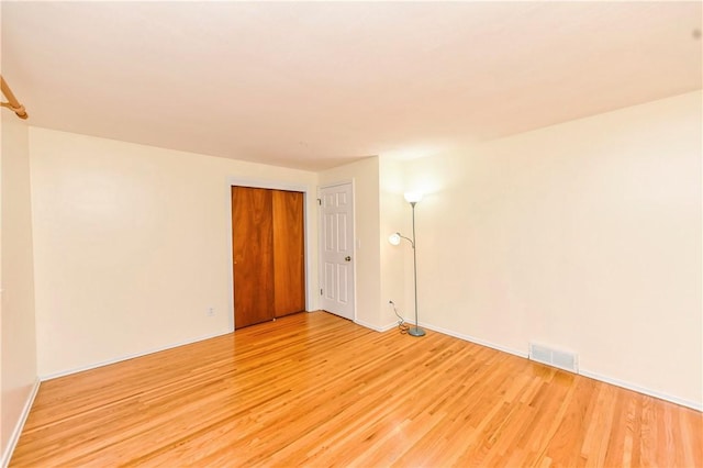 empty room with light hardwood / wood-style floors