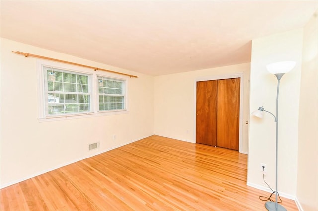 spare room with light hardwood / wood-style flooring