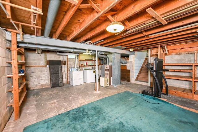 basement with heating unit and washer and dryer