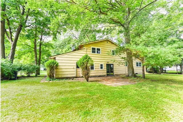 back of property featuring a lawn