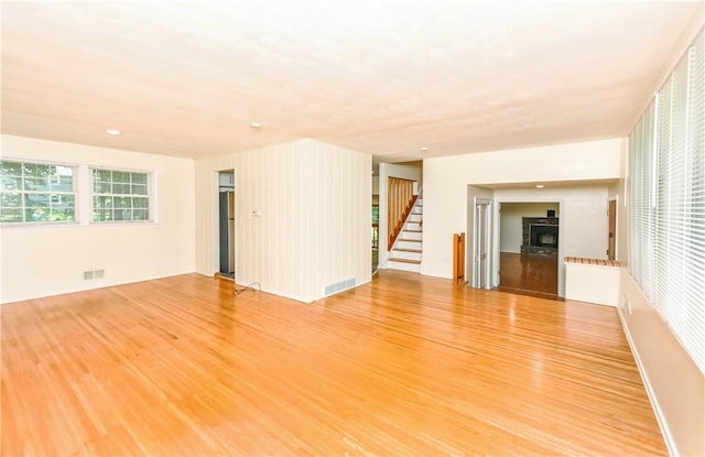 unfurnished living room featuring wood-type flooring