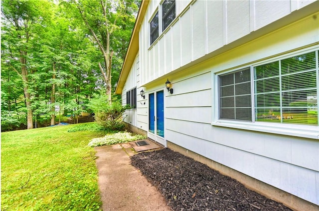 view of property exterior with a lawn