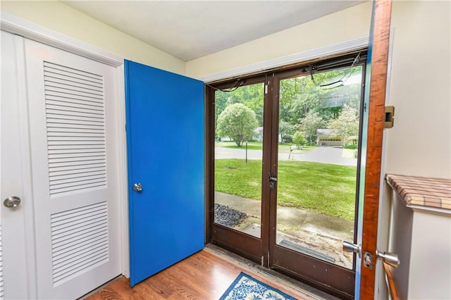 doorway with french doors and light hardwood / wood-style flooring