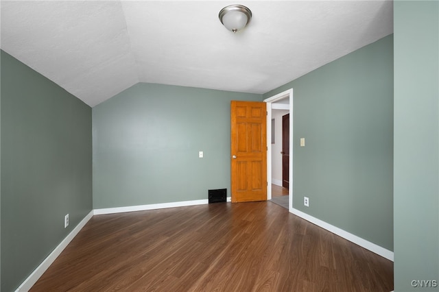 additional living space featuring dark hardwood / wood-style floors and vaulted ceiling