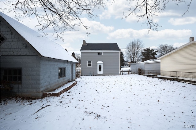 view of snow covered rear of property