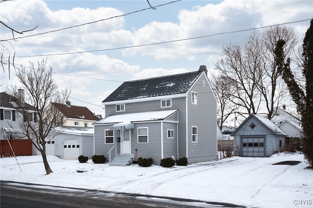 view of property with an outdoor structure and a garage