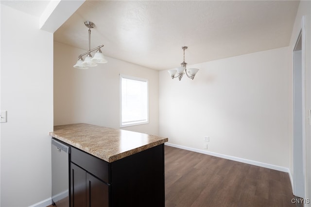 kitchen featuring dark hardwood / wood-style floors, dishwasher, hanging light fixtures, and an inviting chandelier