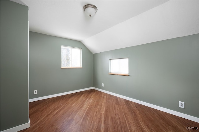 bonus room with hardwood / wood-style floors and vaulted ceiling