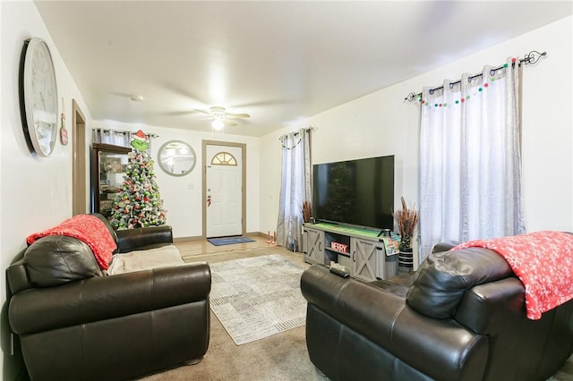 carpeted living room with ceiling fan