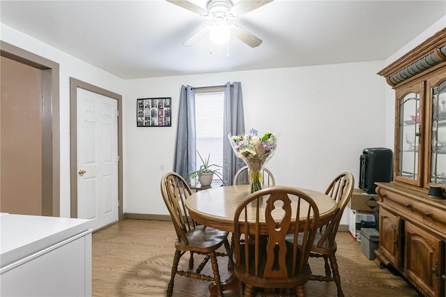 dining room with ceiling fan and light hardwood / wood-style floors