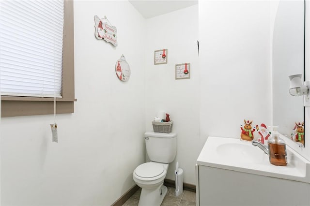 bathroom with tile patterned flooring, vanity, and toilet