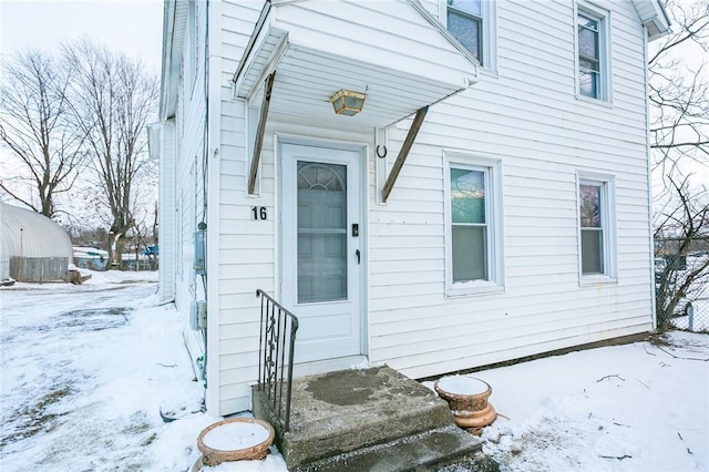 view of snow covered property entrance