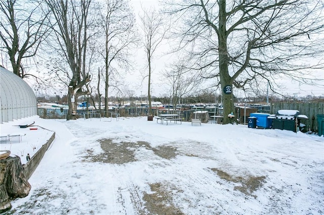 snowy yard featuring a trampoline