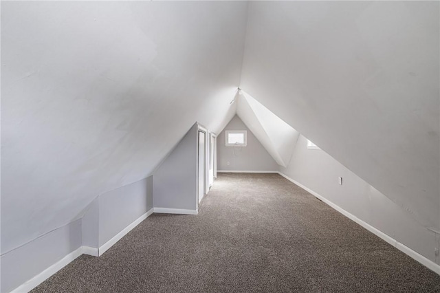 additional living space with carpet flooring and lofted ceiling