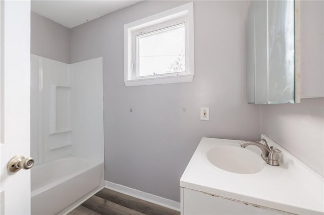 bathroom with vanity, wood-type flooring, and washtub / shower combination