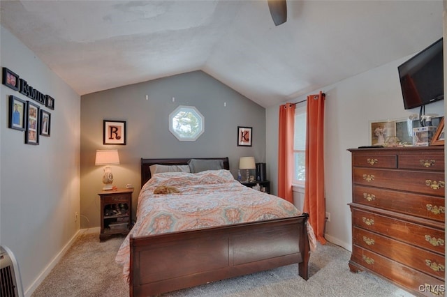 carpeted bedroom featuring lofted ceiling and ceiling fan