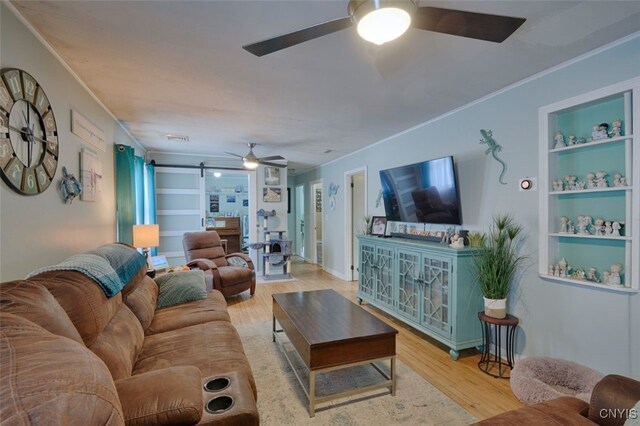 43804 Second St, Alexandria, NY 13679 - living room featuring a ceiling fan, wood finished floors, ornamental molding, and built in features
