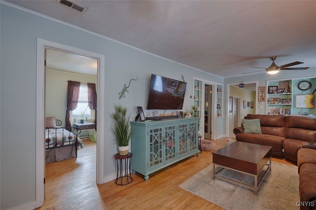 43804 Second St, Alexandria, NY 13679 - living room featuring ornamental molding, wood-type flooring, a ceiling fan, and baseboards