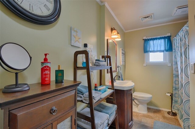 bathroom with crown molding, vanity, and toilet