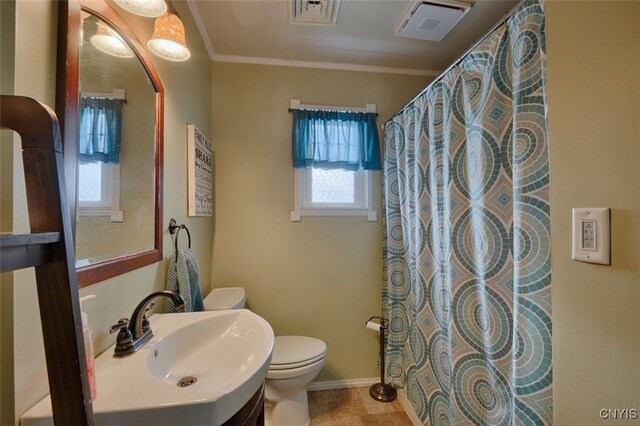 bathroom with toilet, curtained shower, crown molding, and sink