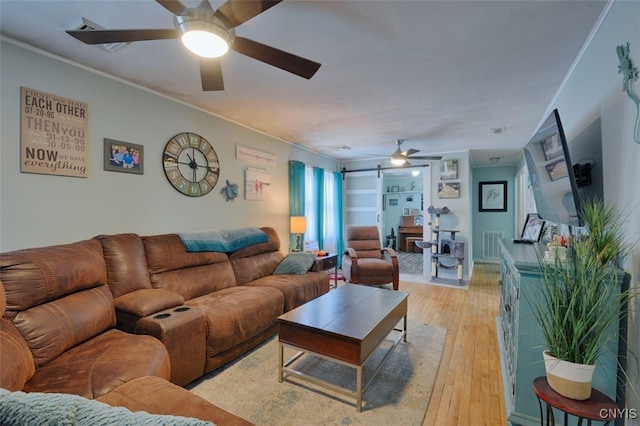 living room with ceiling fan and light wood-type flooring