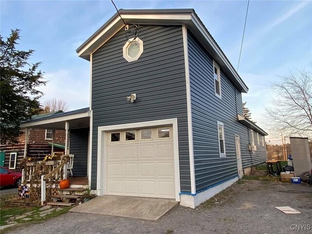 43804 Second St, Alexandria, NY 13679 - view of property exterior with an attached garage and covered porch