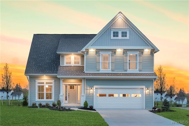 view of front facade with a lawn and a garage