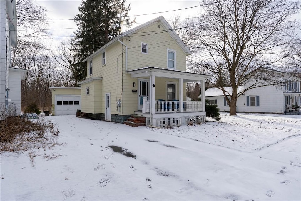 view of front of house featuring a garage and an outdoor structure