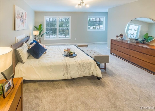 carpeted bedroom featuring a notable chandelier