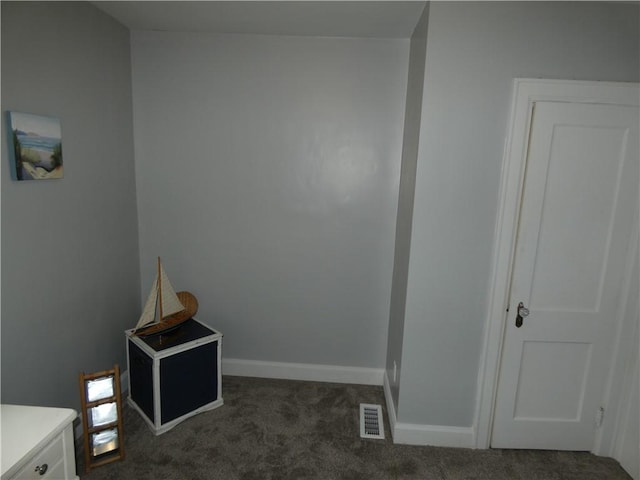 interior space featuring dark colored carpet