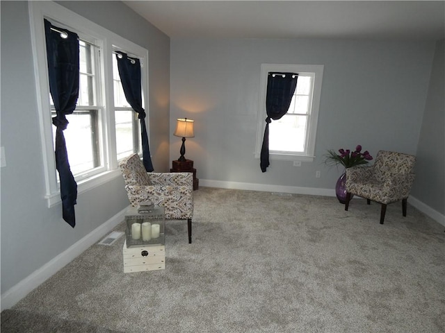 sitting room with a healthy amount of sunlight and light colored carpet