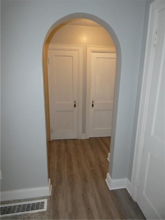 corridor featuring dark hardwood / wood-style floors