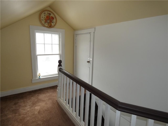 corridor featuring carpet and lofted ceiling