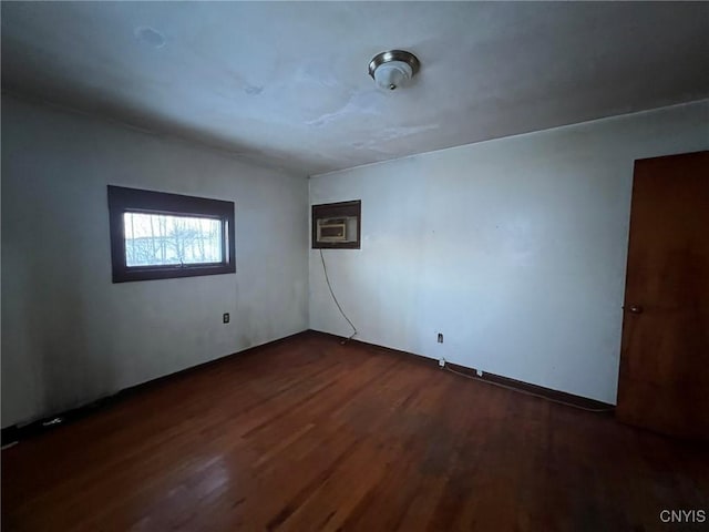 empty room with dark wood-type flooring