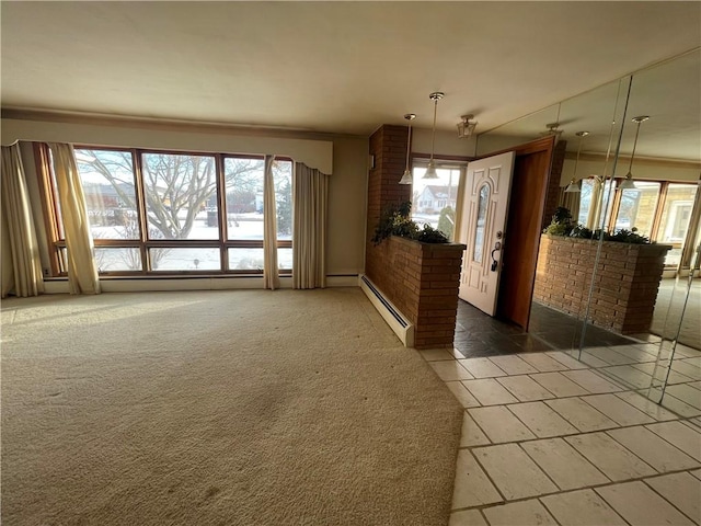 interior space with carpet flooring and a baseboard heating unit