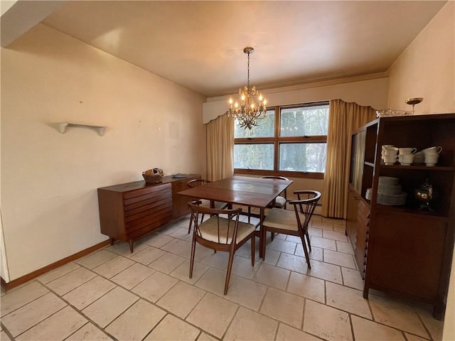 tiled dining space featuring a chandelier and a baseboard heating unit