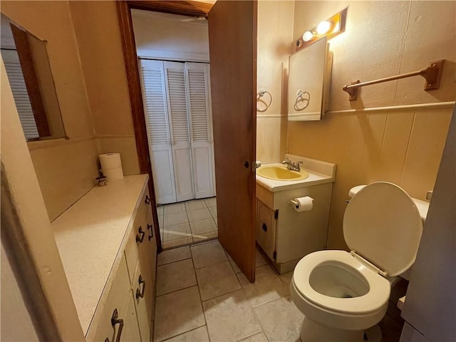 bathroom featuring tile patterned floors, vanity, and toilet