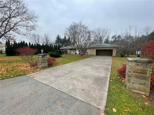 view of front of property featuring a garage and a front lawn