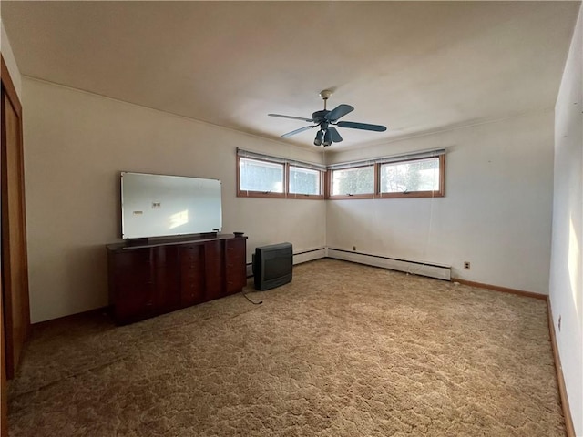 interior space featuring carpet flooring, ceiling fan, and baseboard heating