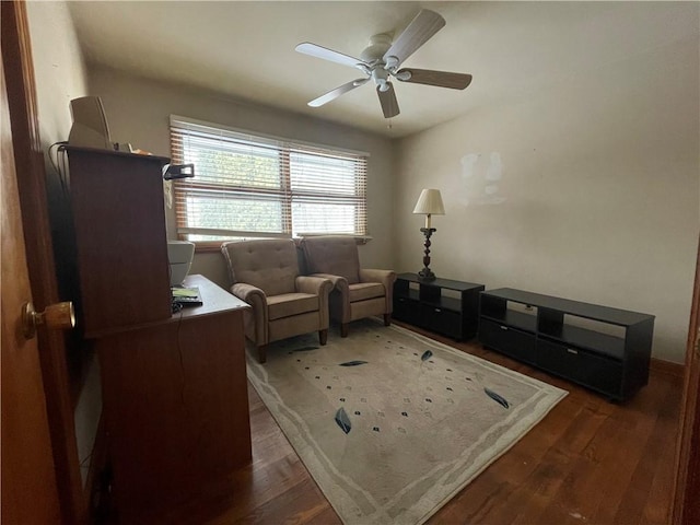 sitting room with ceiling fan and dark hardwood / wood-style flooring