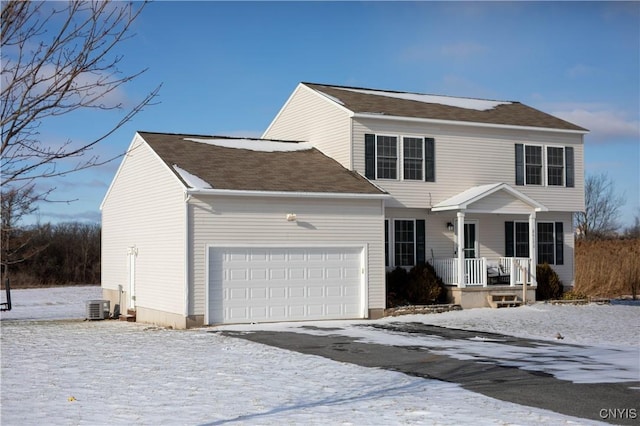 view of front property featuring a garage and central AC